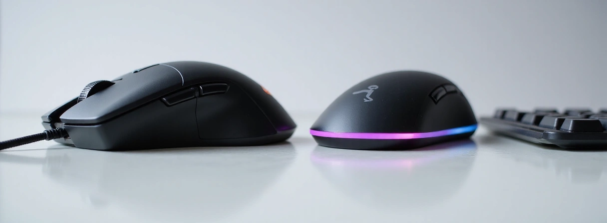 Two different computer mice or keyboards side-by-side on a clean surface, highlighting differences.
