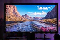 A high-refresh-rate gaming monitor displaying a vibrant game scene